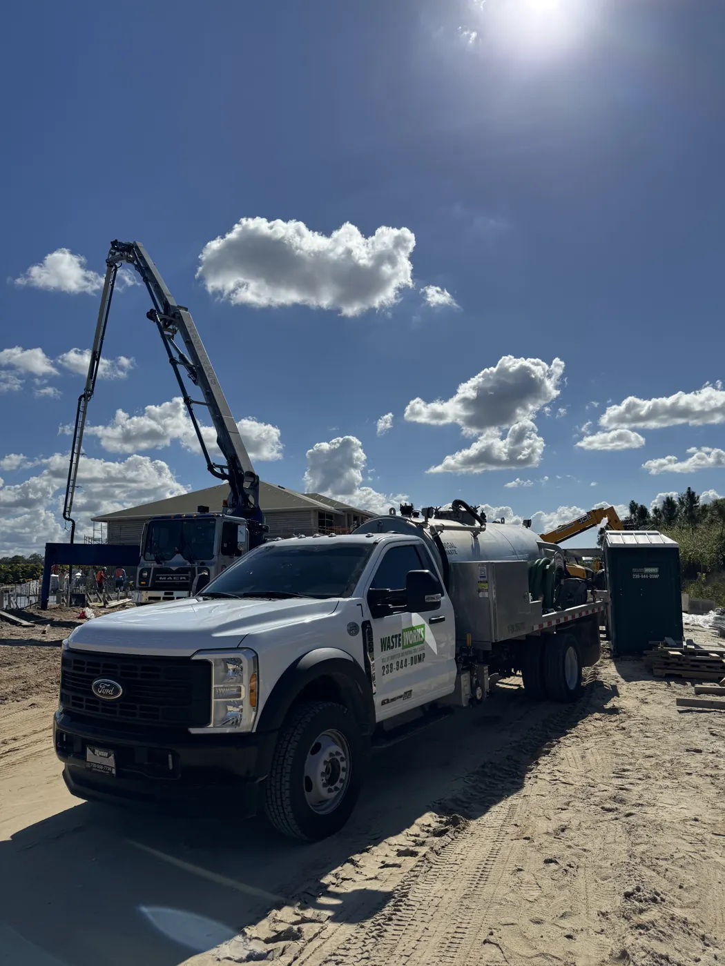 Waste Works service truck and portable toilets at a work site